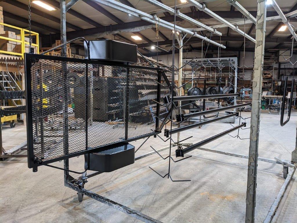 Twain mesh panel and rails on the powder coat line
